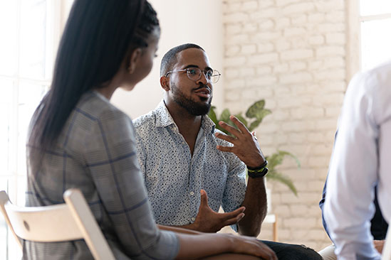 Man in group talking.